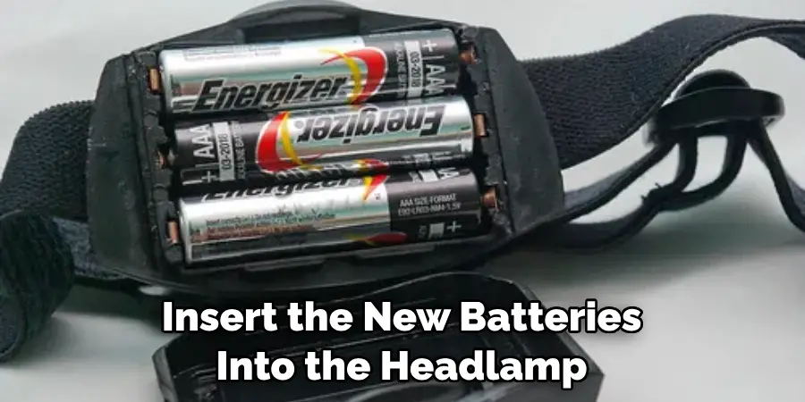 Insert the New Batteries Into the Headlamp