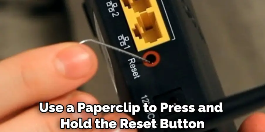 Use a Paperclip to Press and Hold the Reset Button