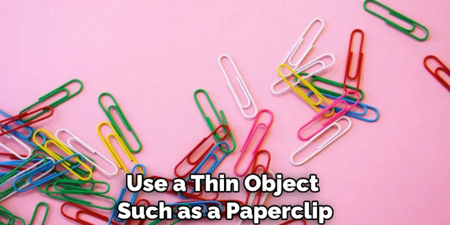 Use a Thin Object Such as a Paperclip