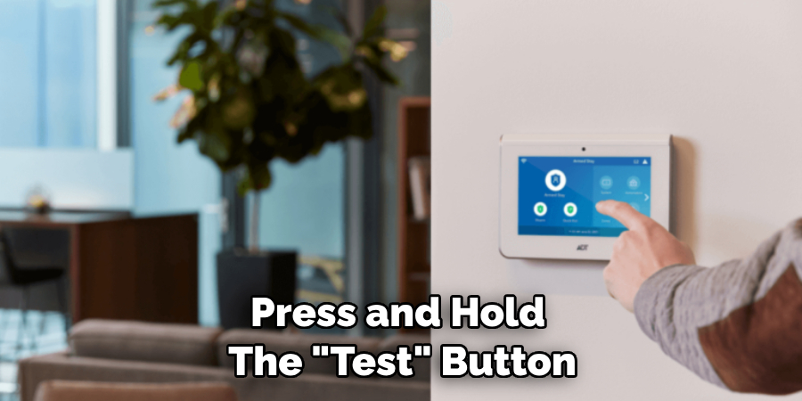 Press and Hold the "Test" Button