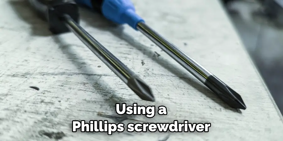 Using a Phillips screwdriver