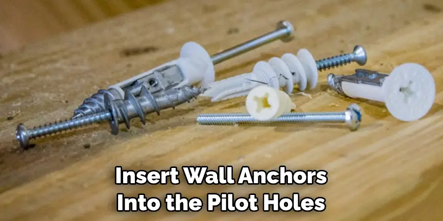 Insert Wall Anchors Into the Pilot Holes