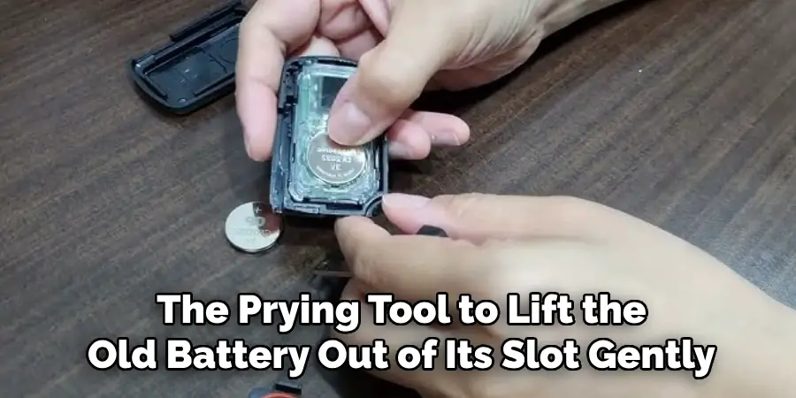 The Prying Tool to Lift the Old Battery Out of Its Slot Gently