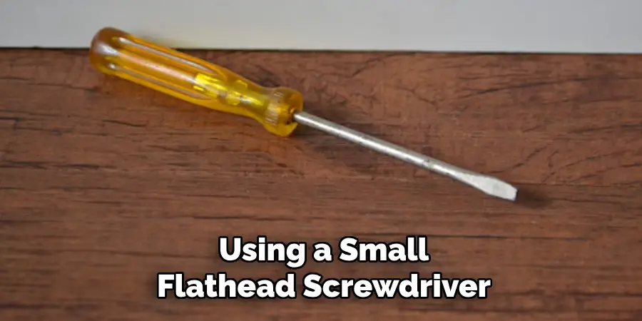Using a Small Flathead Screwdriver