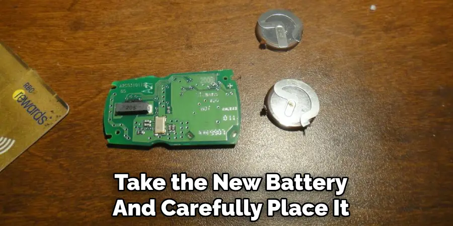 Take the New Battery
And Carefully Place It 