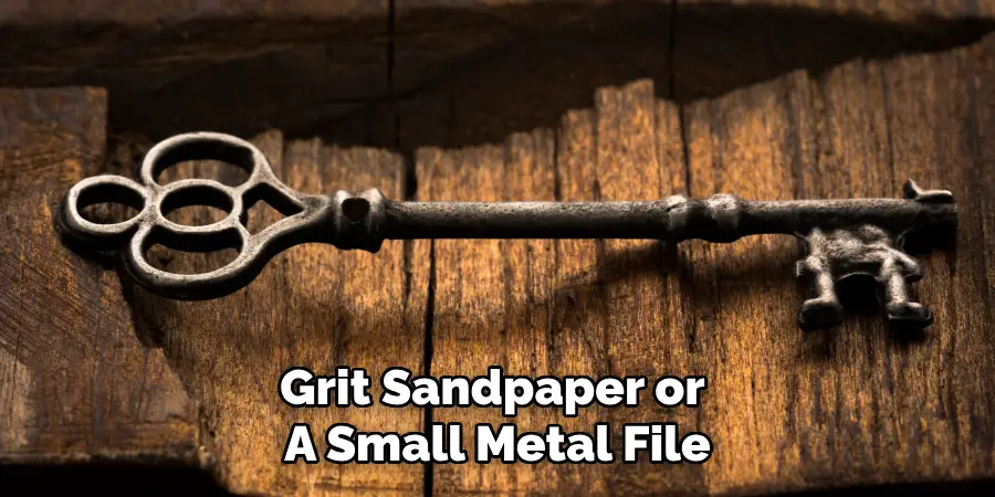 Grit Sandpaper or 
A Small Metal File