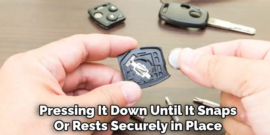 Pressing It Down Until It Snaps Or Rests Securely in Place