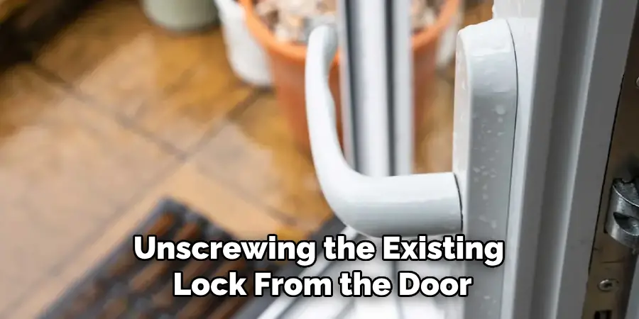 Unscrewing the Existing
Lock From the Door