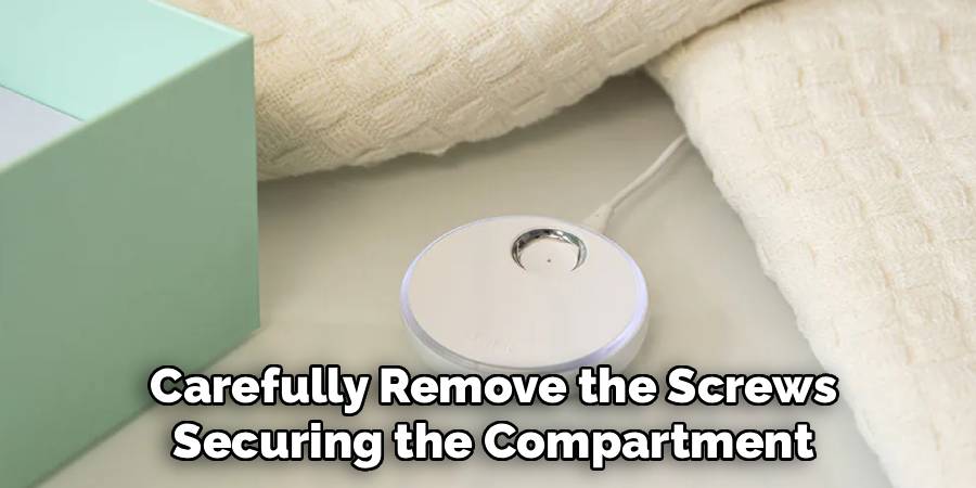 Carefully Remove the Screws
Securing the Compartment