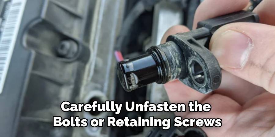 Carefully Unfasten the
Bolts or Retaining Screws