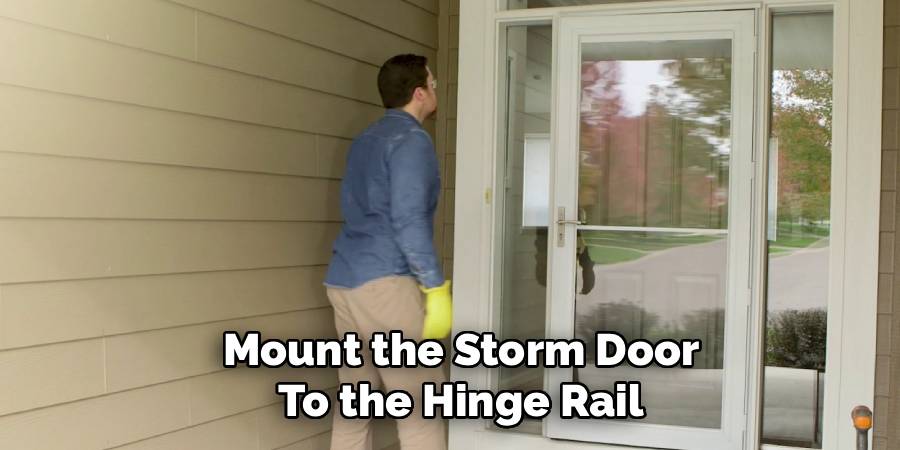 Mount the Storm Door to the Hinge Rail