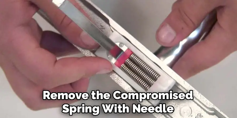 Remove the Compromised
Spring With Needle